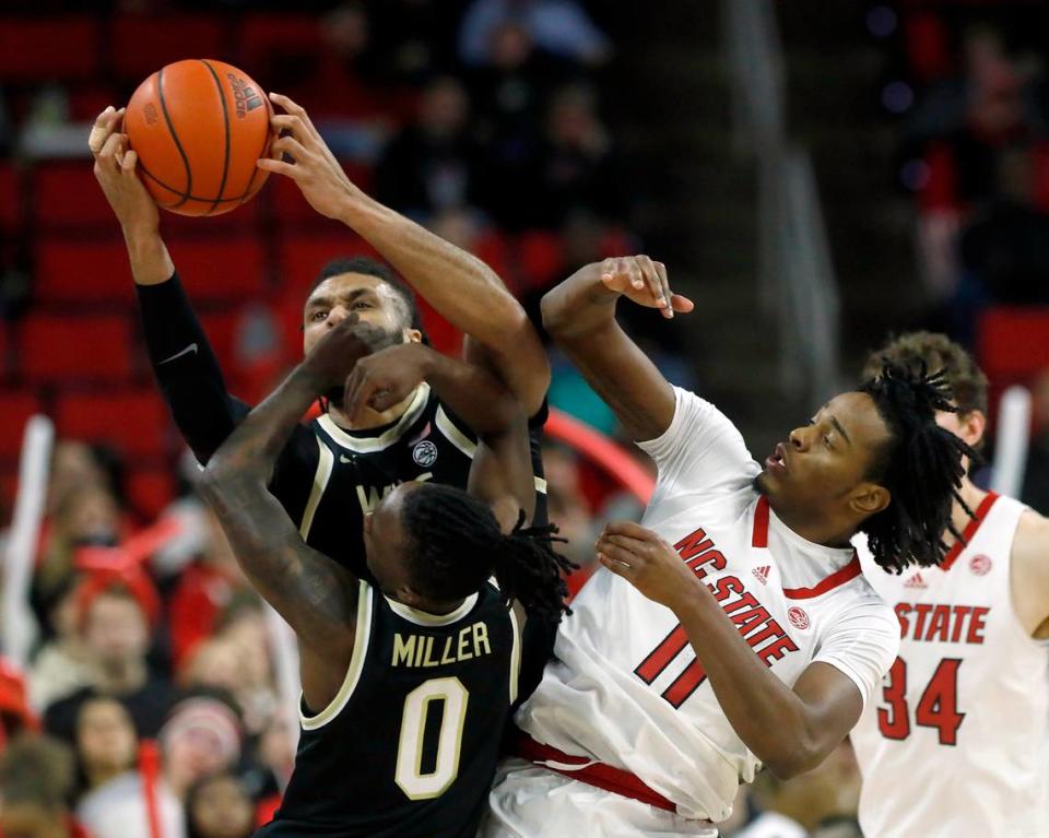 Wake Forest’s Efton Reid III (4) is fouled by N.C. State’s Dennis Parker Jr. during the first half of the Wolfpack’s game at PNC Arena on Tuesday, Jan. 16, 2024, in Raleigh, N.C.