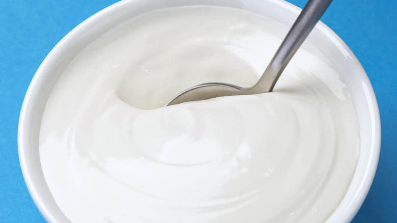 Spoon in jar of sour cream