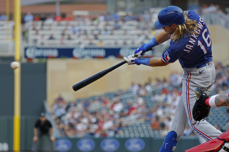 Texas Rangers' Travis Jankowski hits a two-run single against the Minnesota Twins during the third inning of a baseball game Thursday, Aug. 24, 2023, in Minneapolis. (AP Photo/Bruce Kluckhohn)