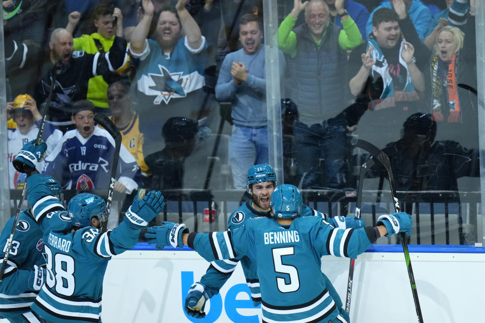 San Jose's Luke Kunin, 2nd right, celebrates with teammates after scoring his sides first goal during the NHL hockey game between San Jose Sharks and Nashville Predators played in Prague, Czech Republic, Saturdday, Oct. 8, 2022. (AP Photo/Petr David Josek)