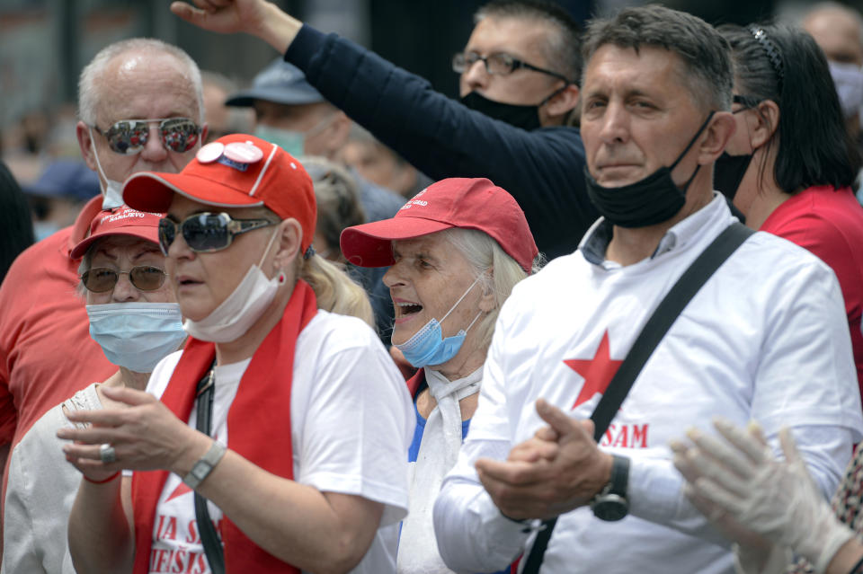 People shout slogans during an anti-Nazi protest outside the Sacred Heart Cathedral during a mass commemorating members of the pro-Nazi Croatian WWII Ustasha regime, responsible for sending tens of thousands of Serbs, Gypsies and Jews to their death in concentration camps, who were killed at the end of WWII by Yugoslav communist troops, in Sarajevo, Bosnia, Saturday, May 16, 2020. Bosnian Catholic clerics along with Croatian state representatives and members of the Bosnian Croats community attended a religious service commemorating the massacre of Croatian pro-Nazis by victorious communists at the end of World War II. (AP Photo/Kemal Softic)