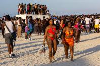 Spring breakers socialize on the beach during Spring Break in Miami Beach, Florida, on Saturday, March 18, 2023.