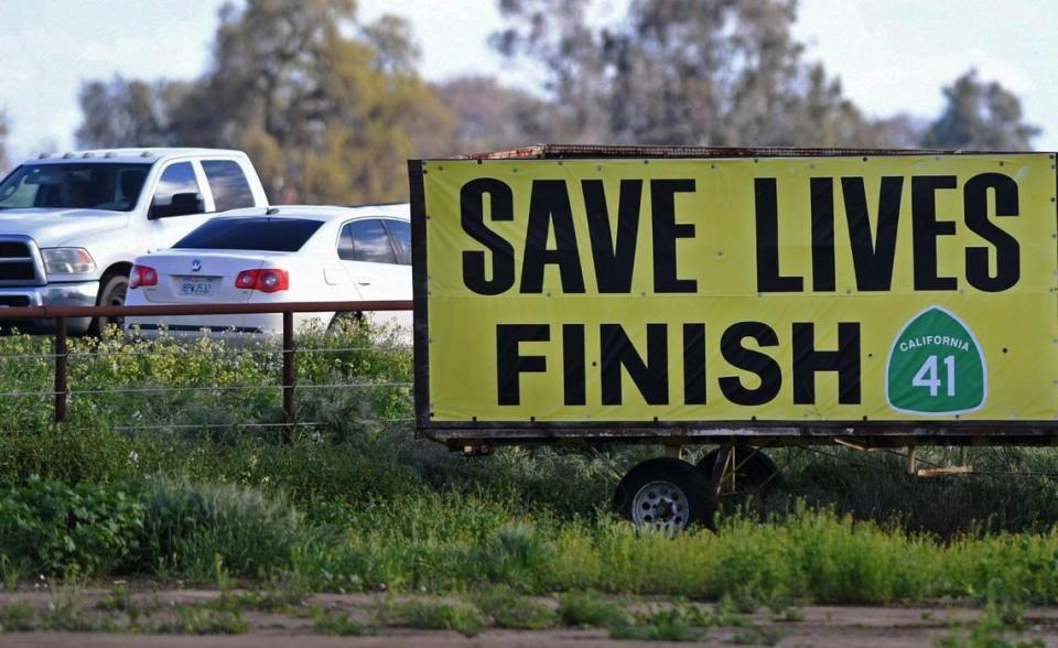 A sign campaigning for the widening of State Route 41 is seen between Excelsior and Elkhorn avenues as narrow single lane traffic passes each other Thursday, March 23, 2023.