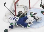 Minnesota Wild goalie Alex Stalock (32) is crashed into by Vancouver Canucks' Loui Eriksson (21) during the second period of an NHL hockey playoff game Thursday, Aug. 6, 2020 in Edmonton, Alberta. (Jason Franson/The Canadian Press via AP)