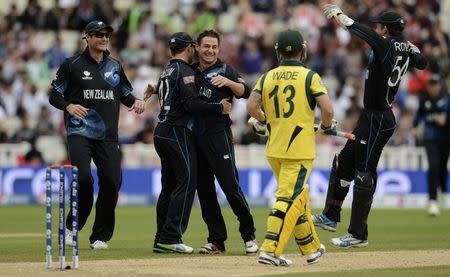 New Zealand's Nathan McCullum (3rd L) is congratulated after dismissing Australia's Matthew Wade (2nd R) during the ICC Champions Trophy group A match at Edgbaston cricket ground, Birmingham. REUTERS/Philip Brown/Files