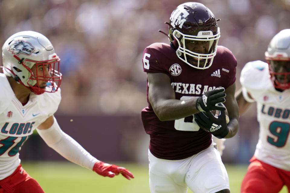 Texas A&M running back Devon Achane (6) runs past New Mexico linebacker Ray Leutele (30) for a touchdown during the first quarter of an NCAA college football game on Saturday, Sept. 18, 2021, in College Station, Texas. (AP Photo/Sam Craft)