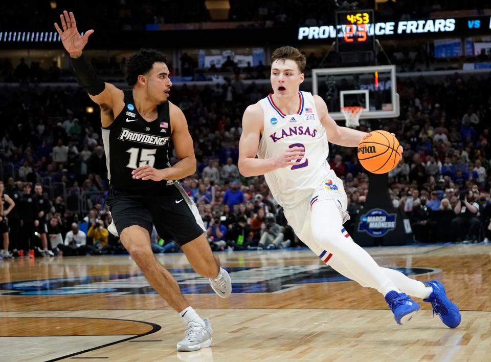 Kansas guard Christian Braun (2) dribbles against Providence forward Justin Minaya (15) during the second half of a NCAA tournament game March 25, 2022, in Chicago.