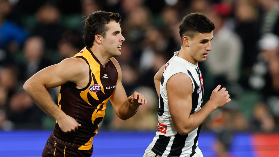 Pictured left, Finn Maginness follows closely behind Collingwood's Nick Daicos in the AFL.