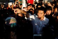 Juangroongruangkit of Thailand's progressive Future Forward Party reacts with his supporters at a sudden unauthorised rally in Bangkok