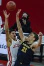 Wisconsin's Jonathan Davis shoots over Michigan's Franz Wagner during the second half of an NCAA college basketball game Sunday, Feb. 14, 2021, in Madison, Wis. (AP Photo/Morry Gash)