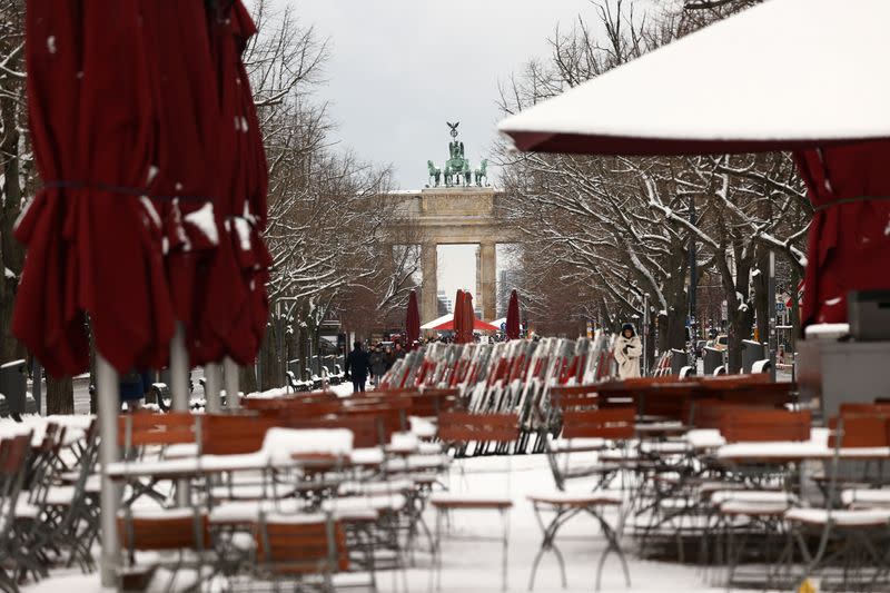 FILE PHOTO: Snow covers the streets and tables near the Brandenburg Gate in Berlin