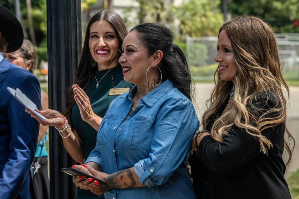 Sonja Shaw, left, president of Chino Valley Unified School District, applauds with Freedom Angels co-founders Denise Aguilar, center, and Tara Thornton after speaking at a news conference at the state Capitol on Monday. The women spoke in opposition to a series of education bills, many supportive of the LGBTQ community, that they say would infringe on parental rights and remove local control in school districts.