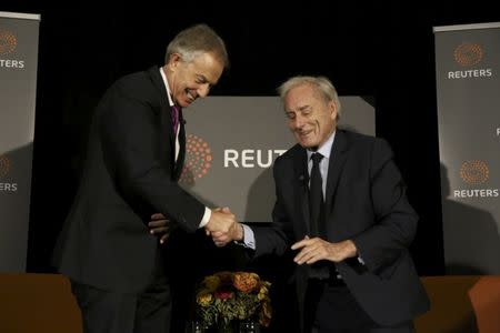 Former British Prime Minister Tony Blair shakes hands with Reuters Editor-at-Large Sir Harold Evans (R) as Evans moderates a Reuters Newsmaker conversation "Politics on the Edge," with Blair in Manhattan, New York, U.S., September 20, 2016. REUTERS/Bria Webb