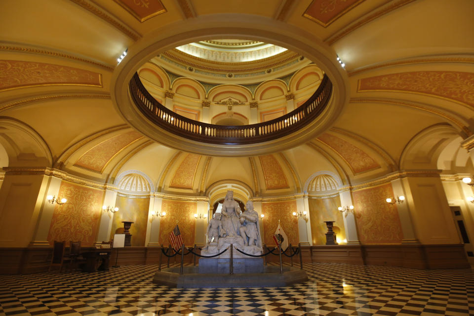 The usually bustling state Capitol rotunda is empty in Sacramento, Calif., Wednesday, March 18, 2020. In a precautionary effort to deal with the coronavirus, the Capitol and Legislative Office Building were closed to the public with only essential state workers and legislative employees allowed in until further notice, based on a "stay at home" directive issued by Sacramento County. (AP Photo/Rich Pedroncelli)