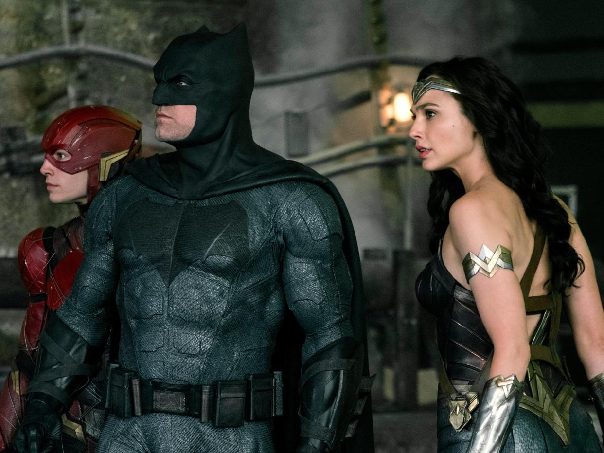 <p>Holding out for a hero: Ezra Miller as The Flash, Ben Affleck as Batman and Gal Gadot as Wonder Woman</p> (Warner Bros)