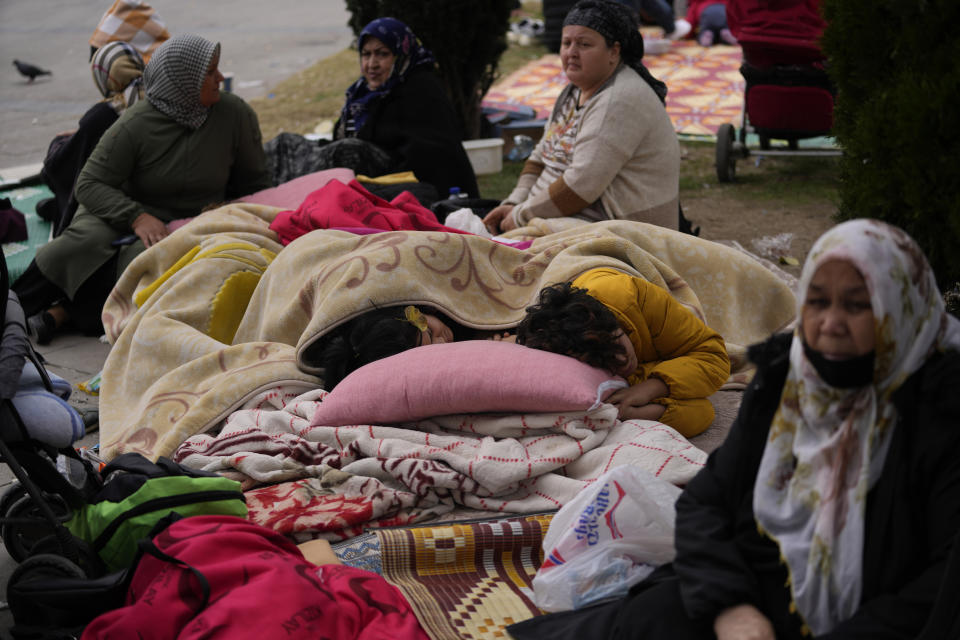 People rest outside their homes in Duzce, Turkey, Wednesday, Nov. 23, 2022, after a magnitude 5.9 earthquake hit a town in northwest Turkey early Wednesday, causing damage to some buildings and widespread panic. At least 68 people were injured, mostly while trying to flee homes. The earthquake was centered in the town of Golkaya, in Duzce province, some 200 kilometers (125 miles) east of Istanbul, the Disaster and Emergency Management Presidency said.(AP Photo/Khalil Hamra)