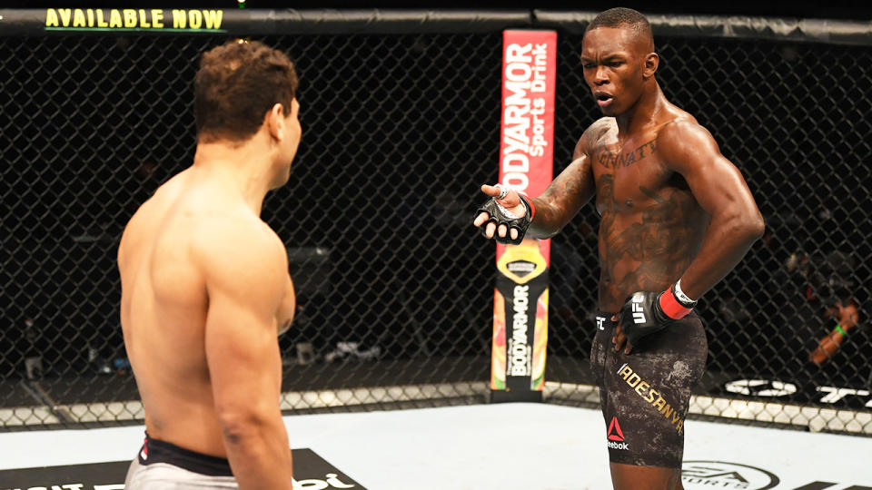 Israel Adesanya looks and gestures to Paulo Costa in their middleweight championship bout.