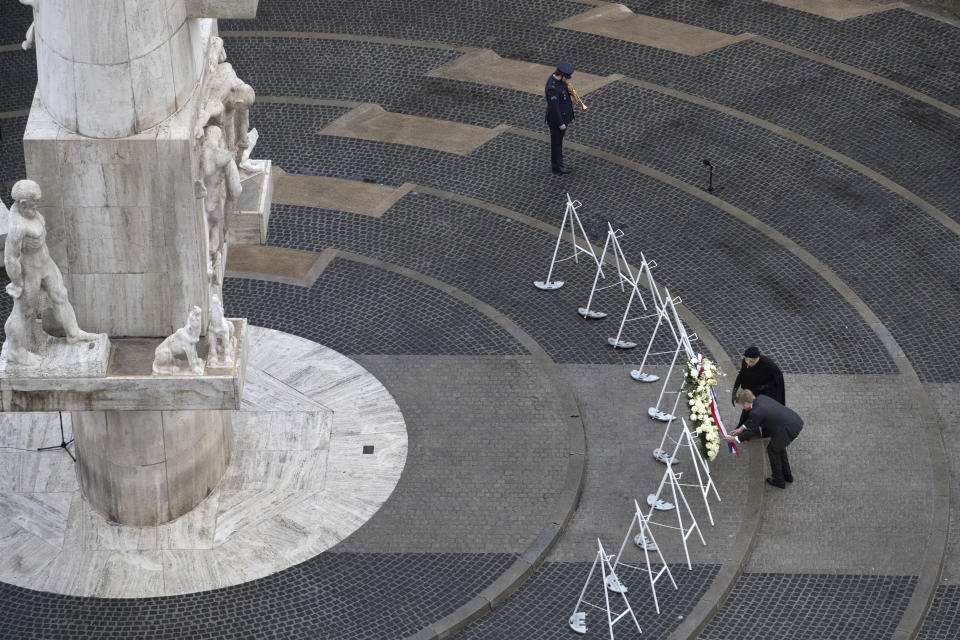 View of Dam Square devoid of spectators due to coronavirus related restrictions, as Dutch King Willem-Alexander and Queen Maxima lay a wreath during a national service to commemorate the war dead in Amsterdam, Netherlands, Tuesday, May 4, 2021. (AP Photo/Peter Dejong, Pool)