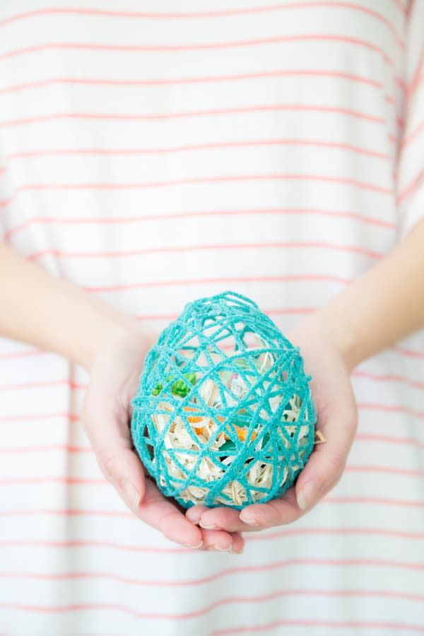 a person holding a small ball