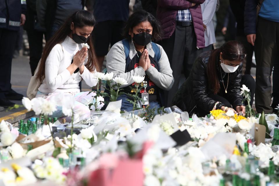 People pay tribute to the victims of the Halloween celebration stampede, on the street near the scene on 1 November 2022 in Seoul, South Korea (Getty Images)