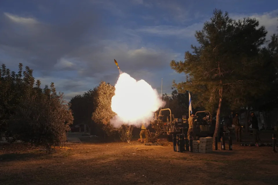 Israeli soldiers fire mortars from southern Israel towards the Gaza Strip, in a position near the Israel-Gaza border, on Wednesday, Dec. 20, 2023. (AP Photo/Tsafrir Abayov)