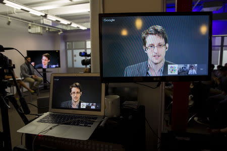 American whistleblower Edward Snowden is seen on monitors as he delivers remarks via video link from Moscow to attendees at a discussion regarding an International Treaty on the Right to Privacy, Protection Against Improper Surveillance and Protection of Whistleblowers in Manhattan, New York September 24, 2015. REUTERS/Andrew Kelly