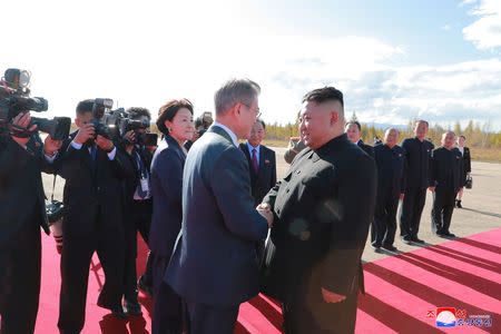 South Korean President Moon Jae-in shakes hands with North Korean leader Kim Jong Un before his departure, in this photo released by North Korea's Korean Central News Agency (KCNA) on September 21, 2018. KCNA via REUTERS