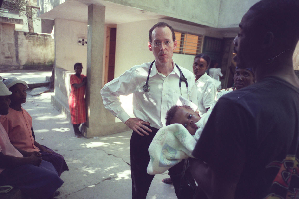 Dr. Paul Farmer listens to a man seeking treatment for his daughter at the Partners in Health hospital in Cange, Haiti, Nov. 2003. (Angel Franco/The New York Times)