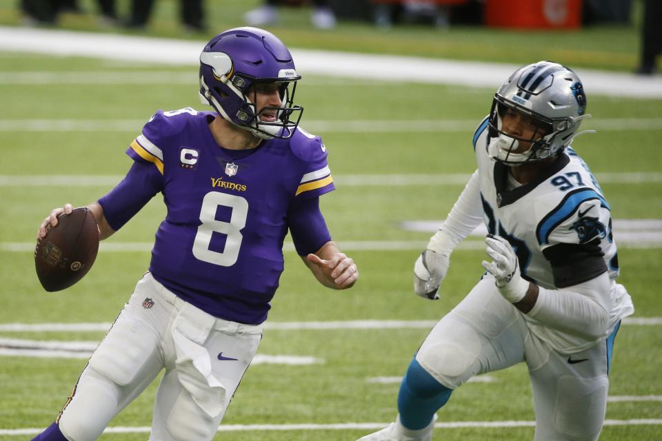 Minnesota Vikings quarterback Kirk Cousins (8) runs from Carolina Panthers defensive end Yetur Gross-Matos (97) during the first half of an NFL football game, Sunday, Nov. 29, 2020, in Minneapolis. (AP Photo/Bruce Kluckhohn)