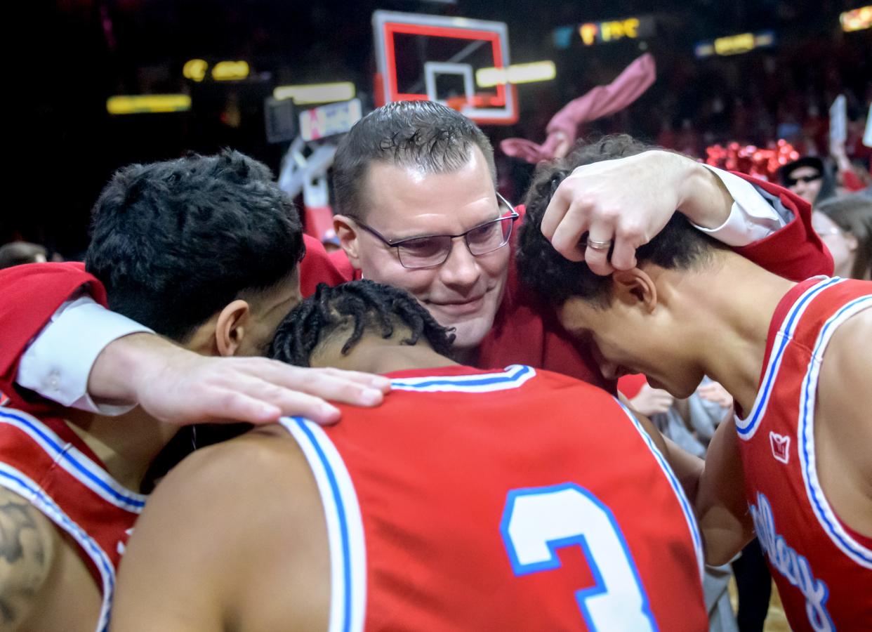 Bradley head coach Brian Wardle hugs a trio of his players as they celebrate their 73-61 victory over Drake to claim the Missouri Valley Conference title Sunday, Feb. 26, 2023 at Carver Arena.