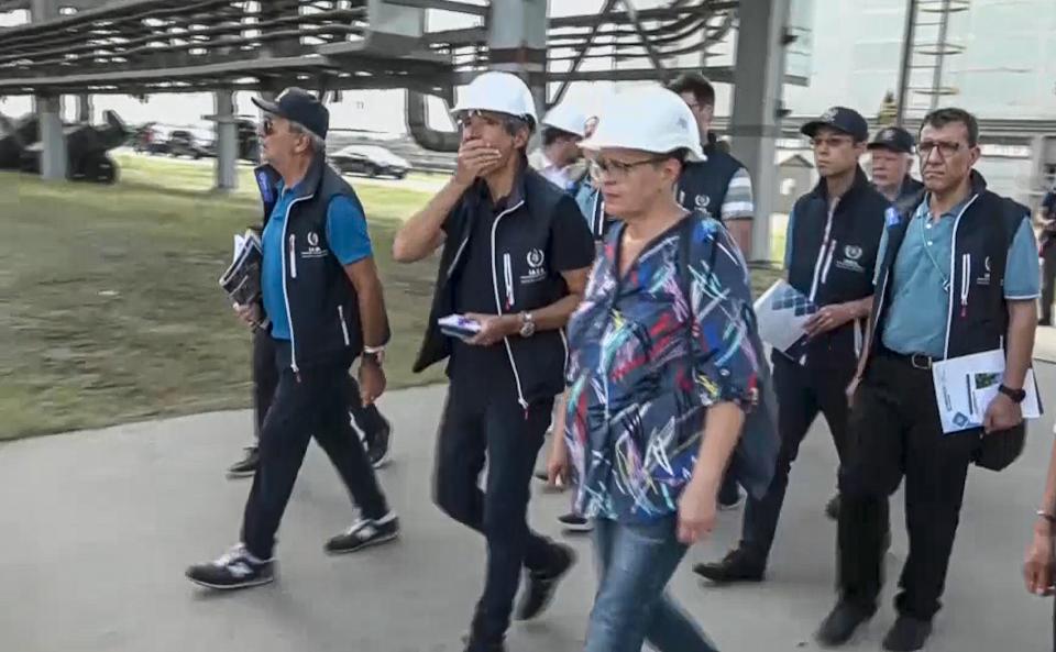 In this handout photo taken from video released by Russian Defense Ministry Press Service on Friday Sept. 2, 2022, International Atomic Energy Agency (IAEA) director Rafael Grossi, the mission leader, center in white helmet, and IAEA members walk while inspecting the Zaporizhzhia Nuclear Power Plant in Enerhodar, southeastern Ukraine Thursday Sept. 1, 2022. A U.N. inspection team has arrived at Ukraine's Zaporizhzhia nuclear power plant on a mission to safeguard it from catastrophe. It reached the site Thursday amid fighting between Russian and Ukrainian forces that prompted the shutdown of one reactor and underscored the urgency and the danger of the task. (Russian Defense Ministry Press Service via AP)