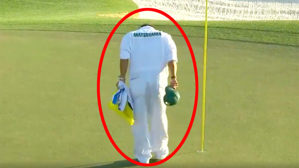 Hideki Matsuyama's caddie was praised for a beautiful gesture after his man claimed the green jacket. Pic: Masters