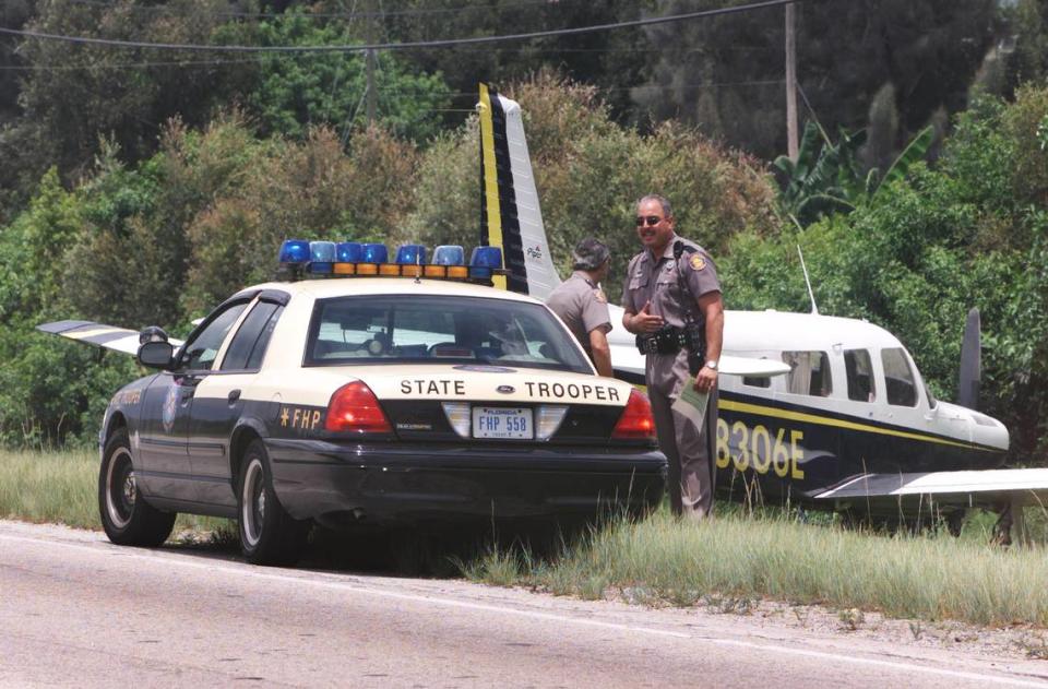 Florida Highway Patrol troopers Nephtali Rivera, left, and R. Kurnick talk on the shoulder of U.S. 27, just north of the turnpike, beside a plane on Aug. 5, 2002. Judge A. Jay Cristol was flying the Piper Saratoga plane from Fort Myers when the oil pressure warning light came on. Marco then took control of the plane as Cristol worked on communication. “I handled the radio and called mayday,” Cristol said. Marco used northbound U.S. 27 as a landing strip, waiting until traffic was clear until landing. A truck pulled in at the last minute and created a close call, but passed before they landed. “We were losing power, 130, 110, 90, 80. We tried to make it to Opa-locka but couldn’t,” Cristol said. “We were very careful not to land before we went below 55, so we wouldn’t get a ticket,” joked Cristol, who was returning from an Angel flight after dropping off two sick children in Fort Myers. The plane wasn’t damaged in the landing.