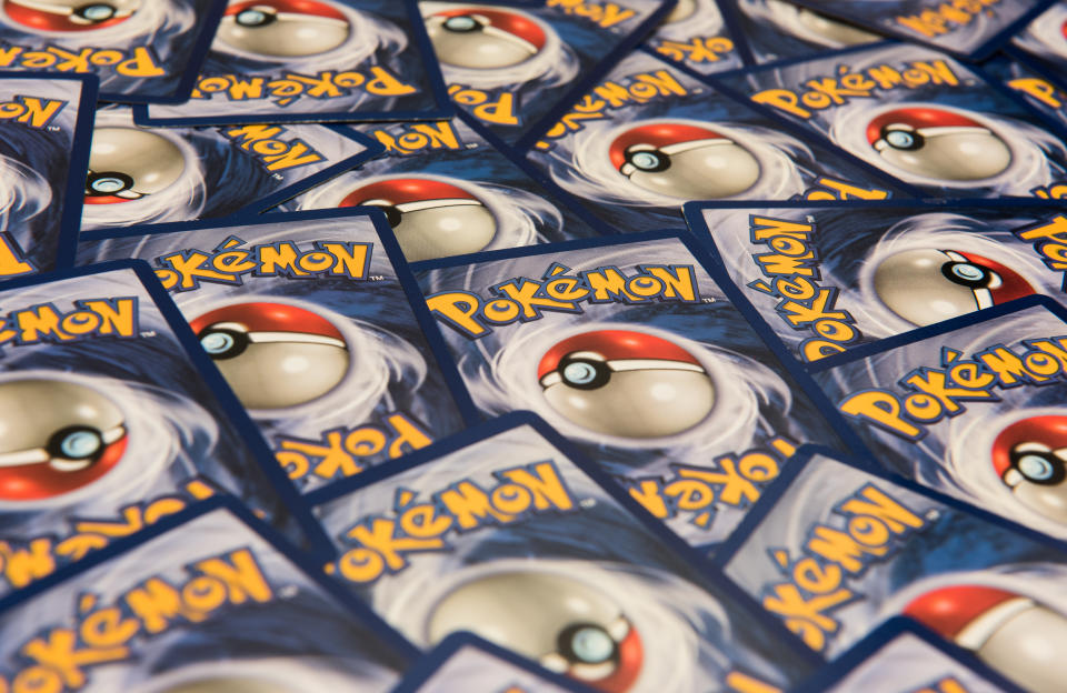 A spread of several Pokémon trading cards, featuring the iconic Poké Ball design on the back of each card