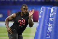 FILE - Kentucky defensive lineman Joshua Paschal runs a drill during the NFL football scouting combine March 5, 2022, in Indianapolis.Paschal and Haskell Garrett count themselves among the lucky ones. They understand only a tiny fraction of football players get a chance to play in the NFL, and even fewer overcome frightening experiences like theirs to become legitimate draft prospects. (AP Photo/Darron Cummings, File)