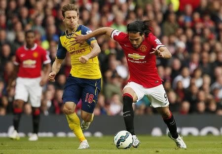 Manchester United's Radamel Falcao in action with Arsenal's Nacho Monreal. Reuters / Phil Noble