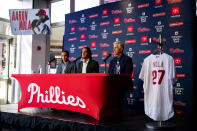 Philadelphia Phillies baseball team pitcher Aaron Nola, center, takes questions from the media after signing a seven-year contract, with President of Baseball Operations David Dombrowski, right, and Vice President and General Manager Sam Fuld, left, Monday, Nov. 20, 2023, in Philadelphia. (AP Photo/Chris Szagola)