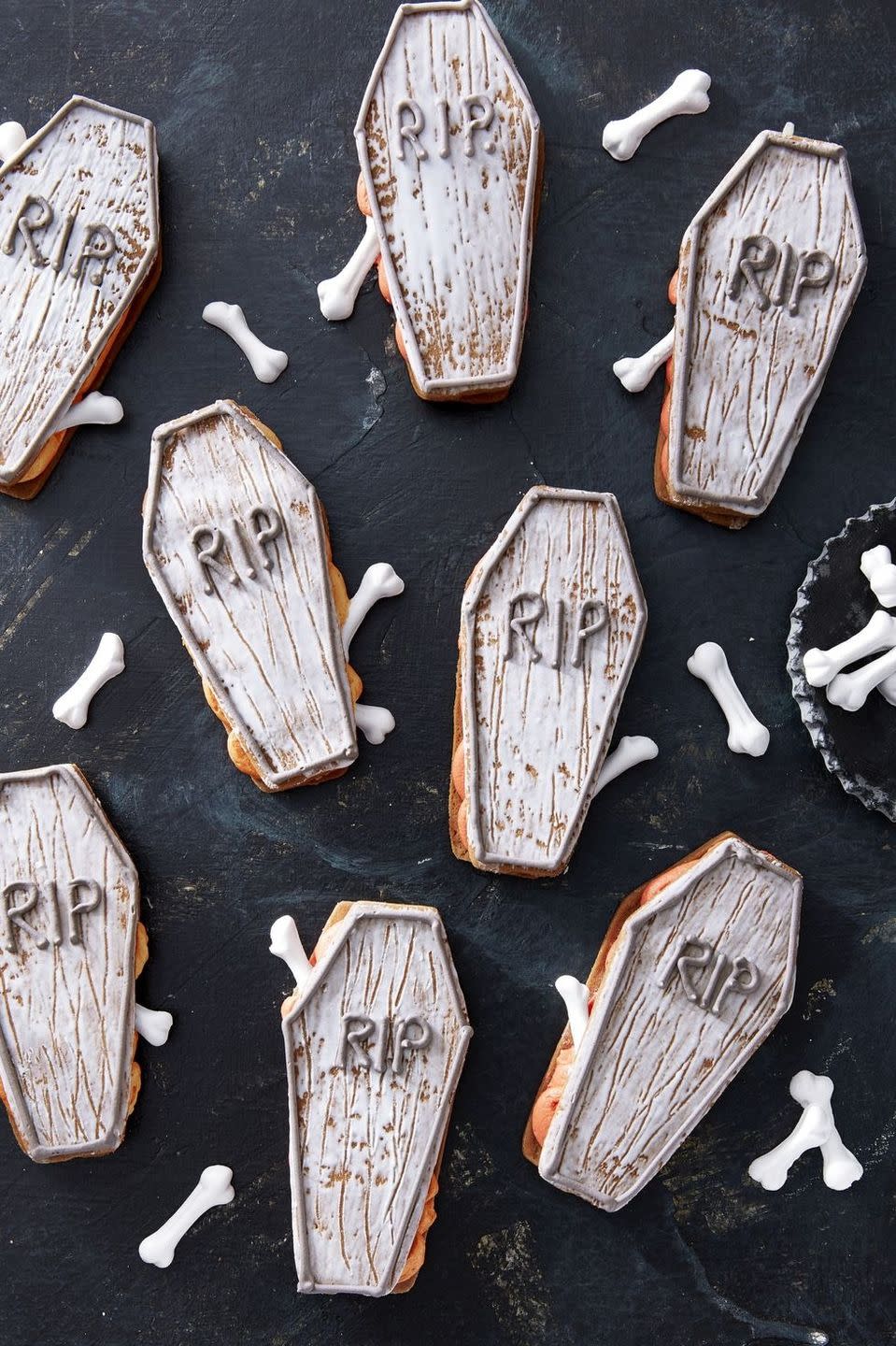 <p>The trick to these life-like treats? Run a fork through the royal icing before it sets to get that creepy, aged effect!</p><p>Get the <strong><a href="https://www.countryliving.com/food-drinks/a28943552/coffin-sandwich-cookies/" rel="nofollow noopener" target="_blank" data-ylk="slk:Coffin Sandwich Cookies recipe;elm:context_link;itc:0;sec:content-canvas" class="link ">Coffin Sandwich Cookies recipe</a></strong> from Country Living. </p>