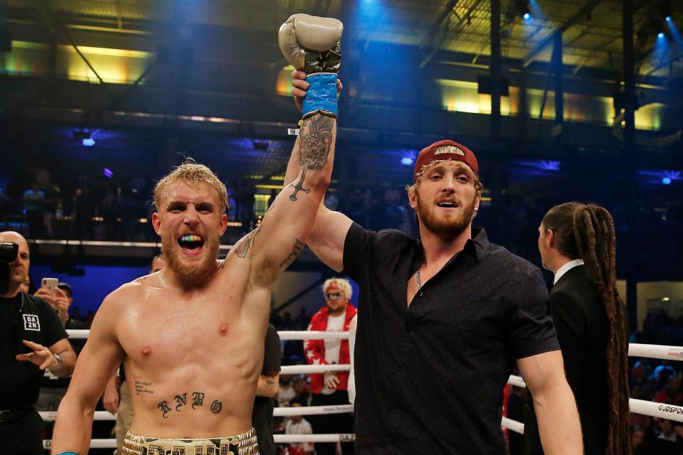 <p>Jake Paul has his hand raised by brother Logan after beating AnEsonGib in January</p> (Getty Images)