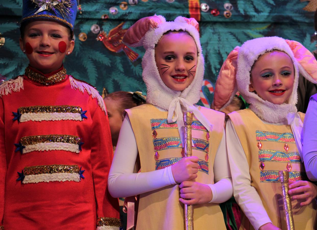 From left, Piper Wright as a toy soldier, and bunnies Hattie McSherry and June Parker, right, take their spots during curtain call practice Wednesday at the Paramount Theatre. The trio are among more than 120 in the casts that four times will present "The Nutcracker" this weekend.