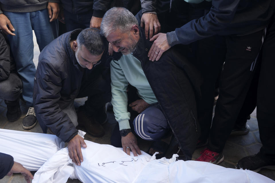 Palestinians mourn over relatives killed in the Israeli bombardments of the Gaza Strip at Al Aqsa Hospital in Deir al Balah, Gaza Strip, on Thursday, Feb. 22, 2024. (AP Photo/Adel Hana)