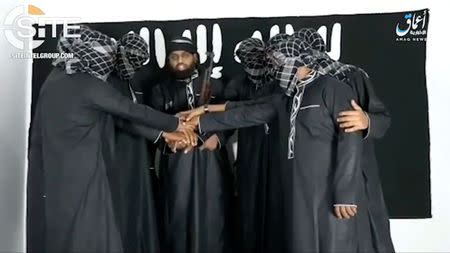 Mohamed Zahran (face uncovered) is seen with a group of men purported to be the the Sri Lanka bomb attackers at an unknown location in this still image taken from video uploaded by the Islamic State's AMAQ news agency April 23, 2019 and received by Reuters via SITE Intel Group. Video uploaded April 23, 2019. The AMAQ via SITE INTEL GROUP/Handout/File via REUTERS TV