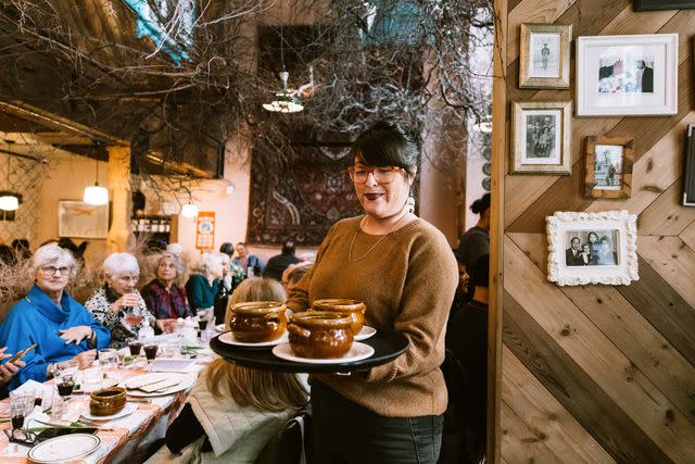 <p>Cheryl Juetten/Courtesy of Kachka</p> Anna-Lisa Chacon, Kachka’s general manager, serves matzo ball soup.