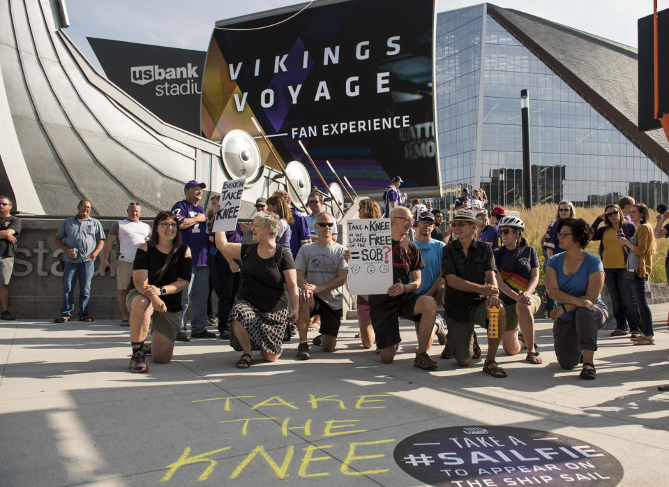 <p>Protestors kneel outside U.S. Bank Stadium before the Minnesota Vikings game in Minneapolis, Minnesota. The protest, in support of Colin Kaepernick, comes days after disparaging statements made by President Donald Trump about players taking a knee during the National Anthem. (Photo by Stephen Maturen/Getty Images) </p>