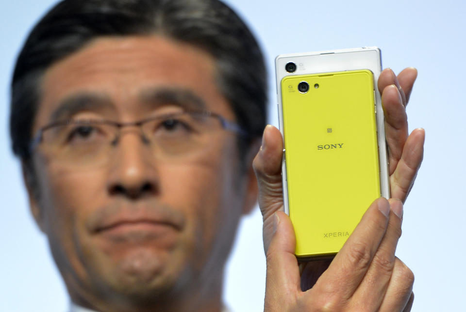 Kunimasa Suzuki, executive vice president, Sony Corporation and president and chief executive officer of Sony Mobile Communications, unveils the new Sony EXPERIA Z1 Compact during the Sony news conference at the International Consumer Electronics Show Monday, Jan. 6, 2014, in Las Vegas. The smaller phone has the same features as the ZPERIA Z1(AP Photo/Jack Dempsey)