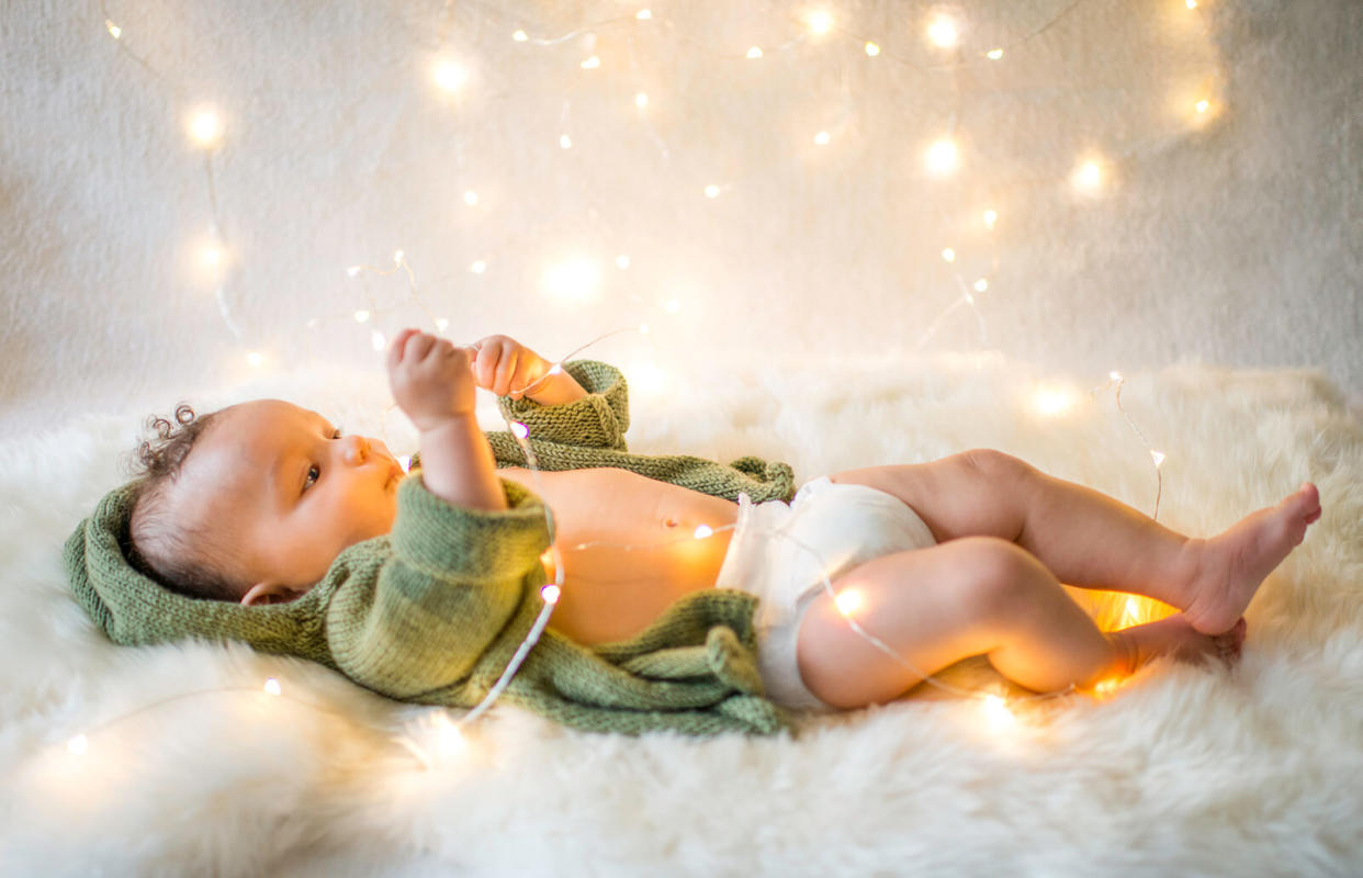 Baby boy playing with decorative lights