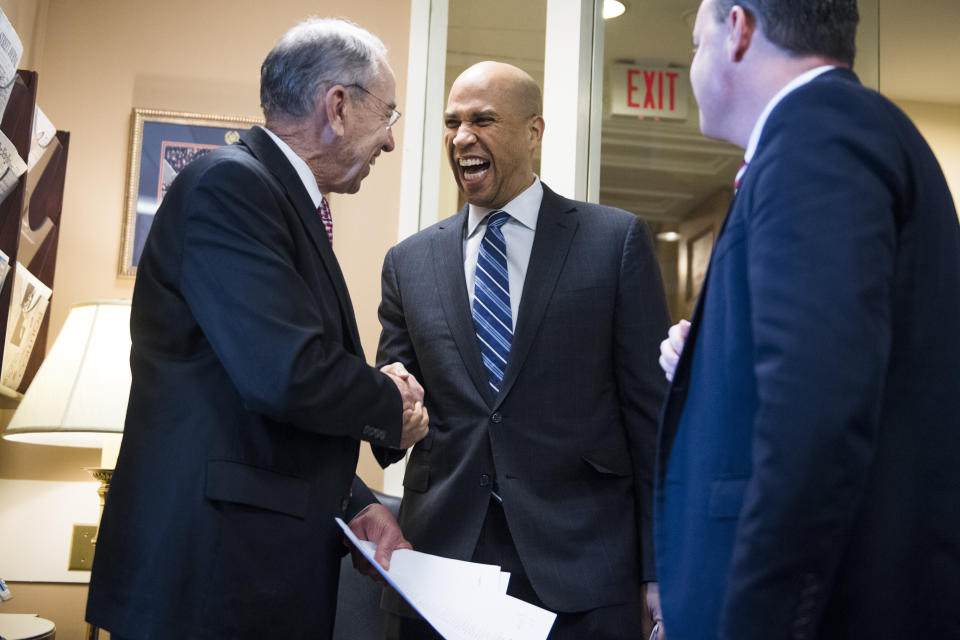 Sen. Cory Booker (D-N.J.) congratulates Republican Sens. Chuck Grassley (Iowa), left, and Mike Lee (Utah) on passage of the First Step Act. (Photo: Tom Williams via Getty Images)