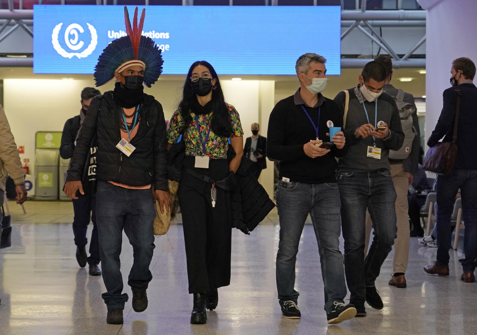 Delegates walk through the venue on another day at the COP26 U.N. Climate Summit in Glasgow, Scotland, Wednesday, Nov. 3, 2021. The U.N. climate summit in Glasgow gathers leaders from around the world, in Scotland's biggest city, to lay out their vision for addressing the common challenge of global warming. (AP Photo/Alberto Pezzali)