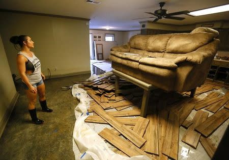 Brandy Cormiar surveys her brother-in-law's flood damaged home in Sorrento, Louisiana, U.S., August 20, 2016. REUTERS/Jonathan Bachman