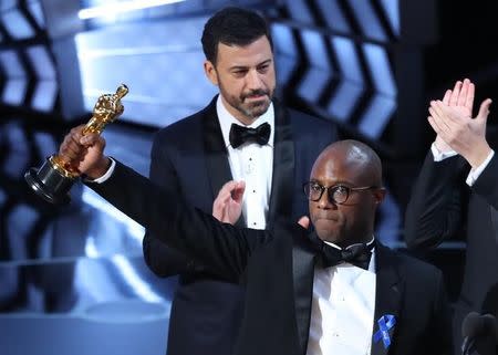 89th Academy Awards - Oscars Awards Show - Hollywood, California, U.S. - 26/02/17 - Writer and Director Barry Jenkins of "Moonlight" holds up the Best Picture Oscar in front of Oscars host Jimmy Kimmel (Rear) REUTERS/Lucy Nicholson